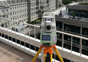 Leica total station on a building rooftop surveying historic Mills Building in Washginton, DC