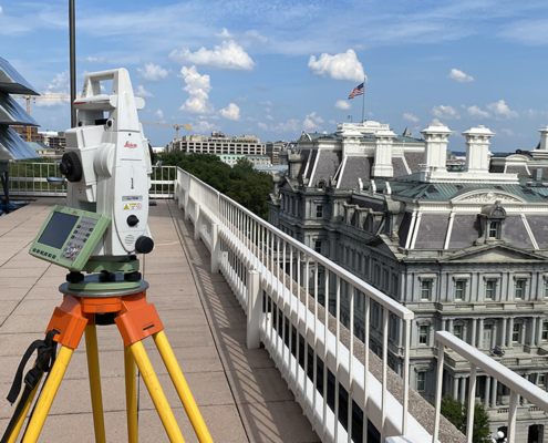 Leica total station on a building rooftop surveying historic Mills Building in Washginton, DC